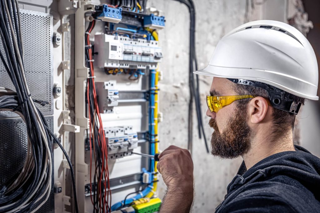 a male electrician works in a switchboard with an 2023 11 27 05 09 59 utc