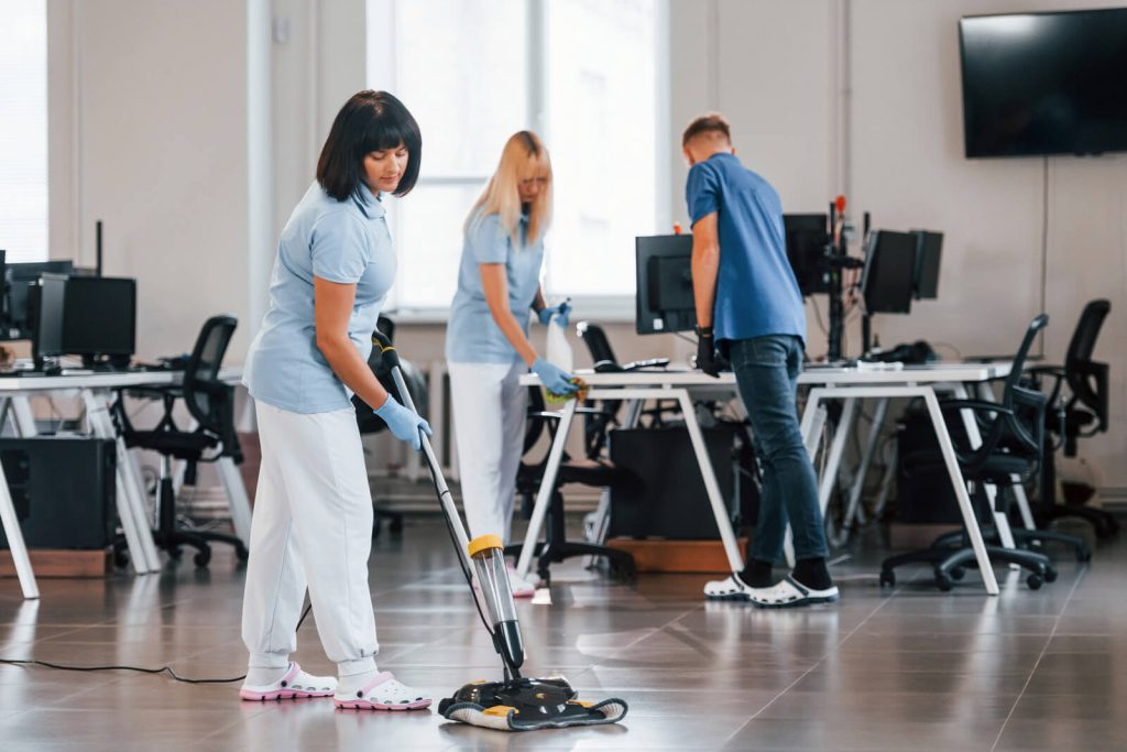 woman uses vacuum cleaner group of workers clean 2023 11 27 05 03 49 utc